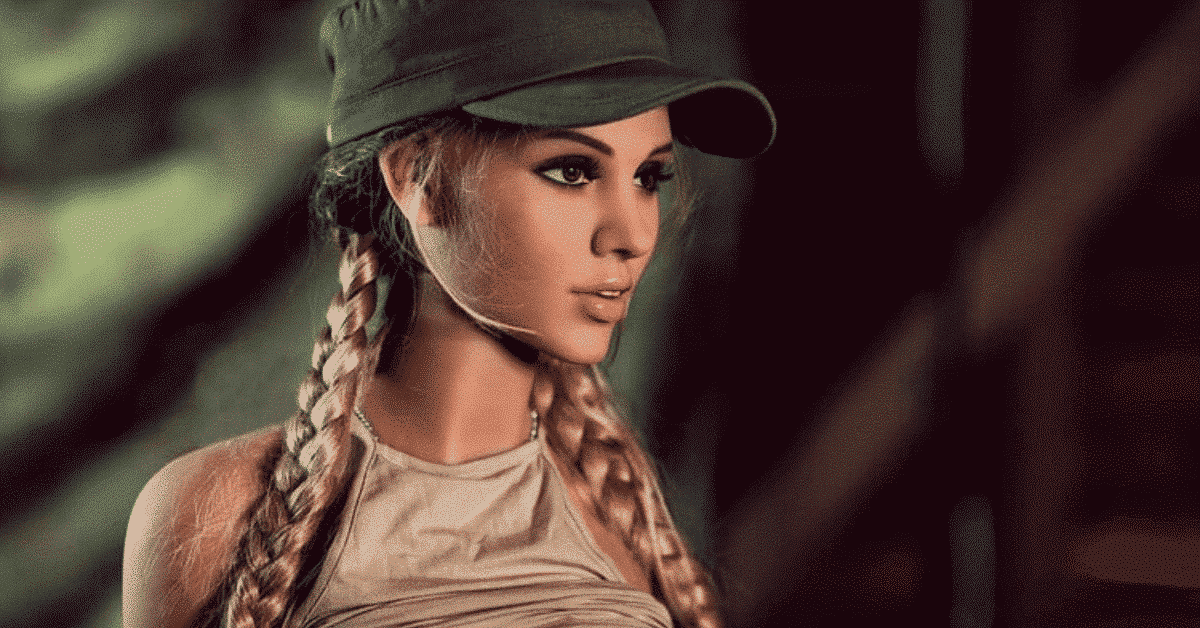 Realistic female doll with braided hair and cap, close-up, neutral indoor background