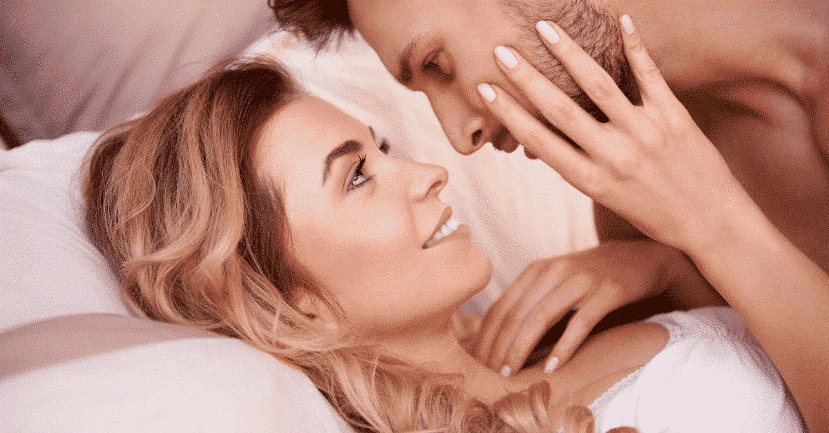 Happy couple in bed sharing an intimate, romantic moment, promoting intimacy and connection