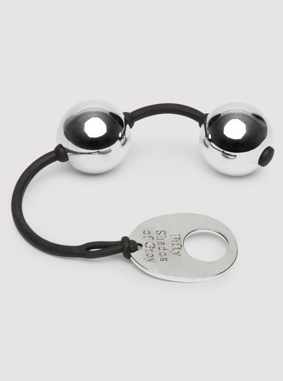 Silver kegel balls connected by a black silicone cord with a metal tag, Fifty Shades of Grey engraving