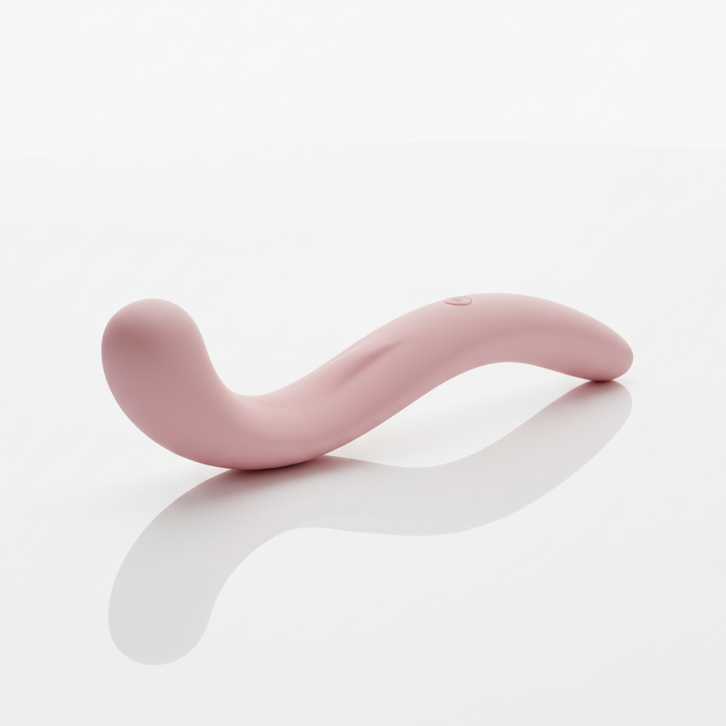 Curved pink G-spot vibrator with smooth silicone surface on white background.