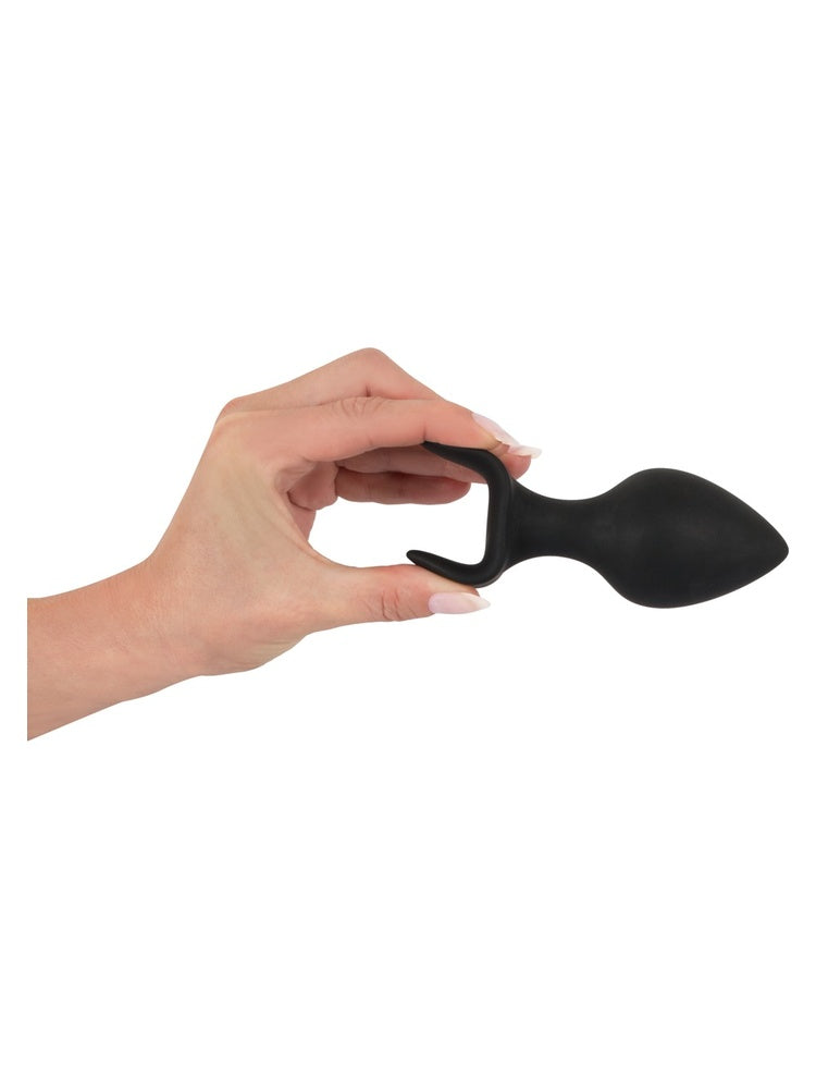Black Velvets Anal Trainer Set – hånd holder stor plug og viser ankerbasen tydelig