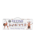 Fetish Fantasy Series Fantasy Bondage Swing emballasje. Hvit eske med produktnavn, bilder av bruk og informasjon om inkluderte hånd- og ankelfester fra Pipedream Products.
