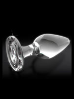 Pipedream Icicles No 26 Buttplug Klar – nærbilde av glaspluggen liggende horisontalt med funkelnde refleksjoner mot mørk bakgrunn