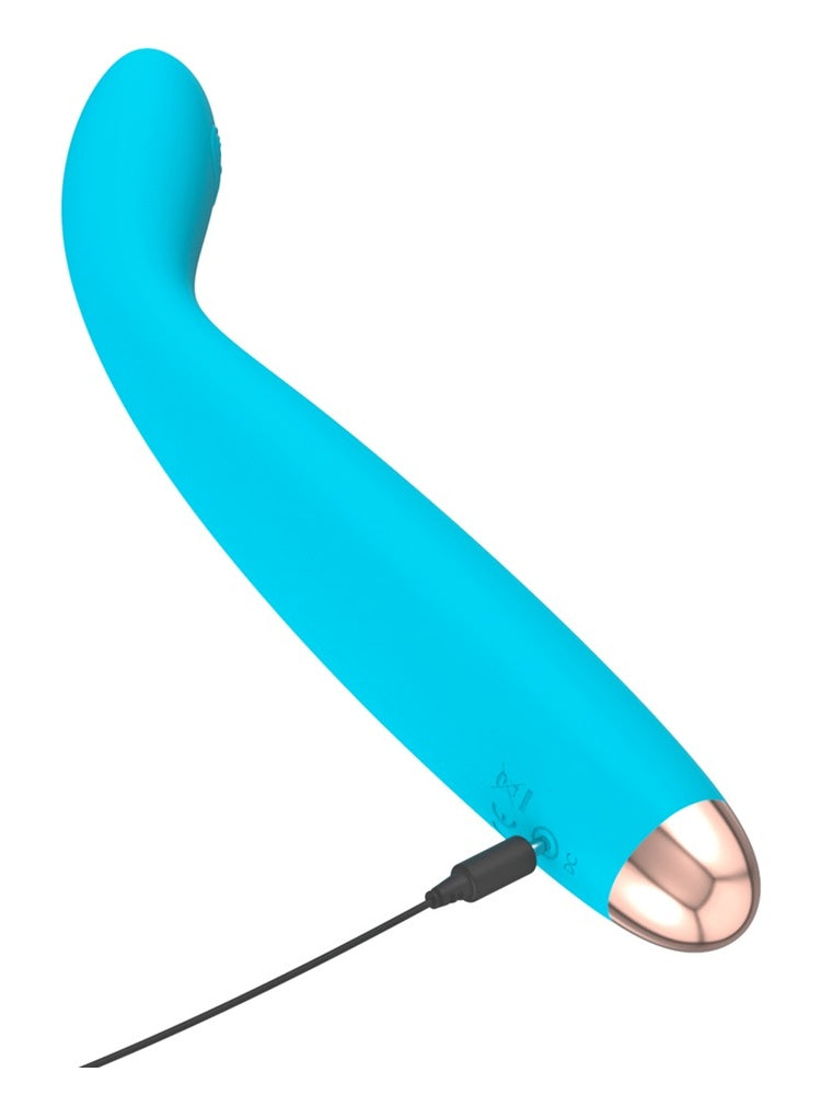 Turkis G-punktvibrator, sett fra siden, med magnetisk USB-ladekabel tilkoblet i bunnen