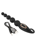 ANOS Analkuler liggende med USB-ladekabel ved siden av