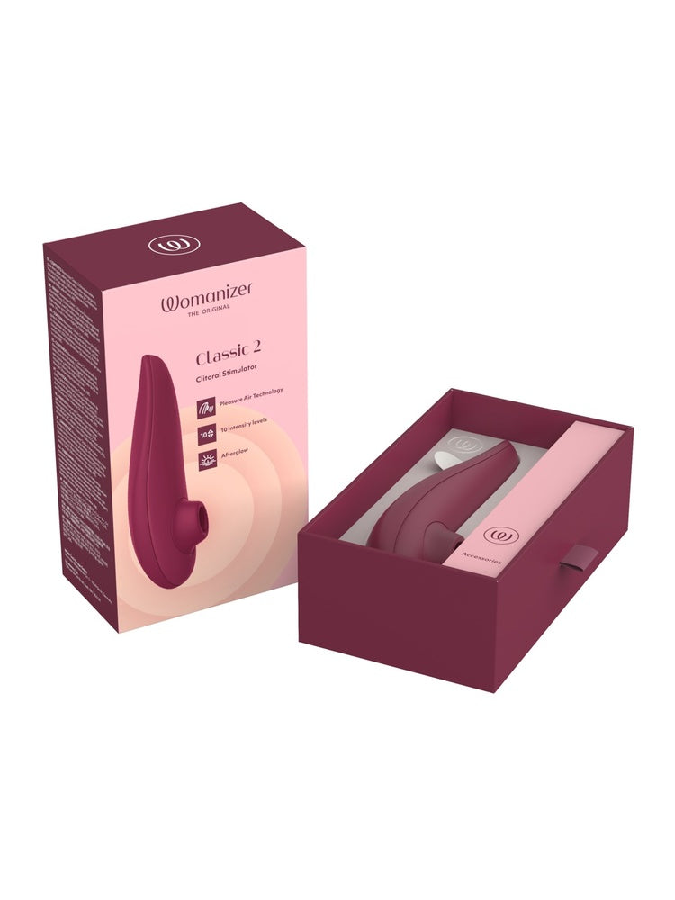 Emballasje og åpen eske med produktet i rød/bordeaux.
