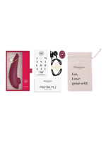 Innhold i pakken: Womanizer Premium 2, ladekabel, ekstra stimulatorhode, oppbevaringspose og guide.