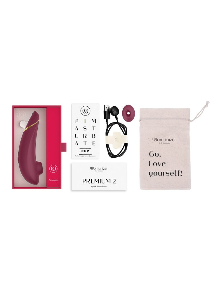 Innhold i pakken: Womanizer Premium 2, ladekabel, ekstra stimulatorhode, oppbevaringspose og guide.