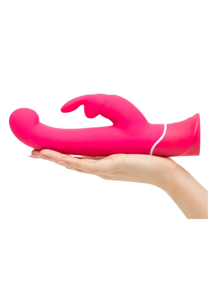 Hånd som holder Happy Rabbit G-punktvibrator i håndflaten, sett fra siden med G-punkt-topp og klitorisarm synlig.