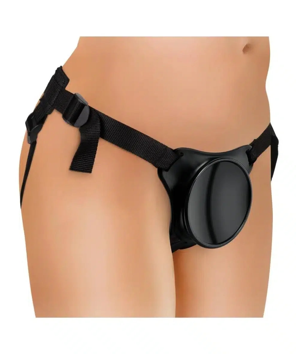 Adjustable black strap-on harness worn on a model's waist and hips