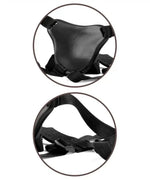 Adjustable black harness with straps and padded front piece, close-up product view