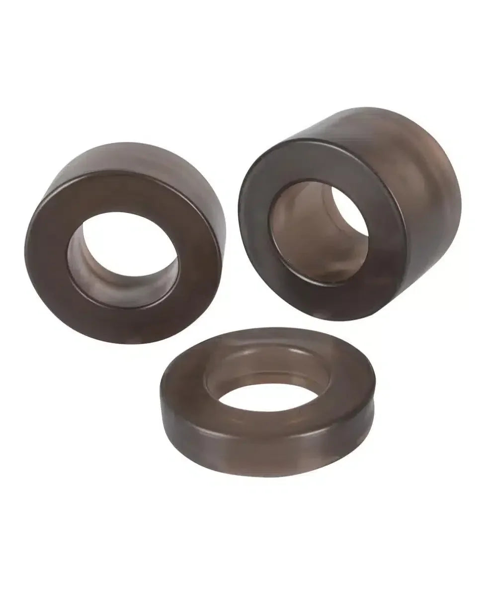 Set of three black silicone rings for intimate use on white background