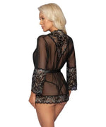 Woman wearing sheer black lace lingerie robe with floral patterns, seen from behind.