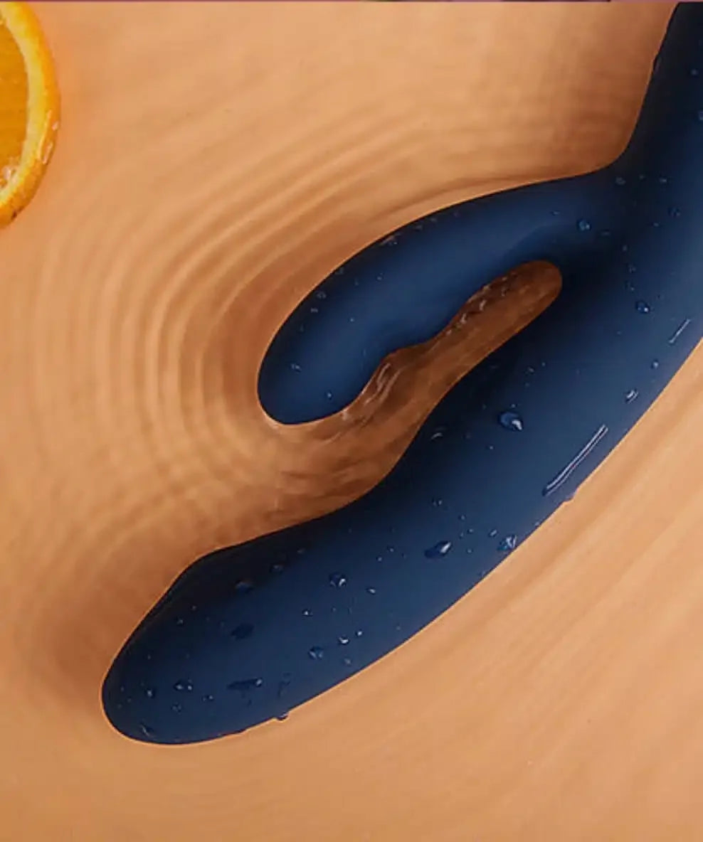 Waterproof navy blue silicone vibrator with curved design and water droplets