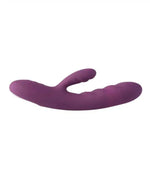 Purple silicone dual-stimulation vibrator with curved, textured design on white background