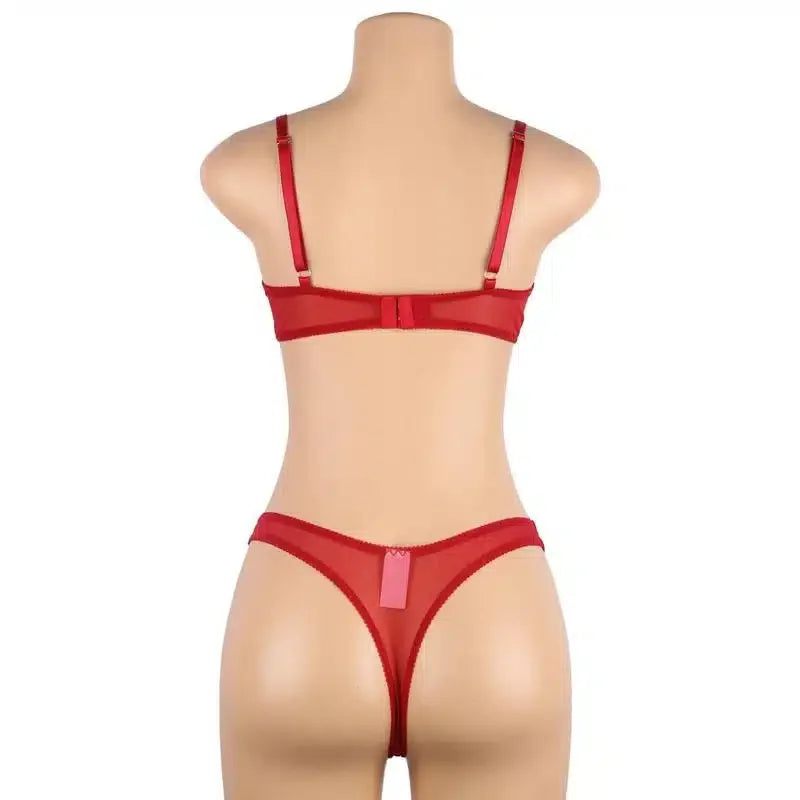 Back view of mannequin wearing red lingerie bra and thong set, adjustable straps visible