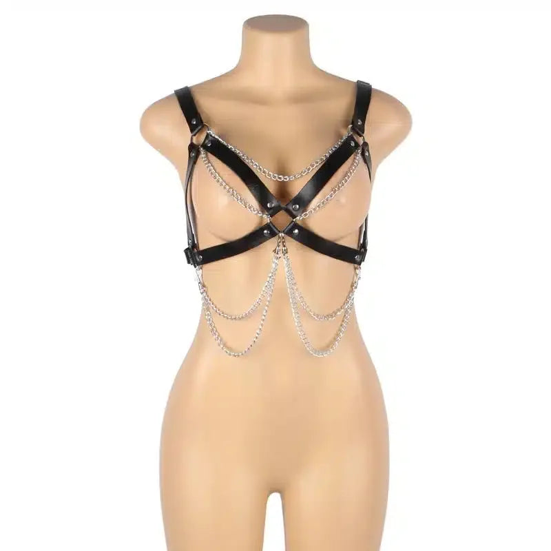 Black leather harness with silver chains on mannequin, erotic lingerie accessory