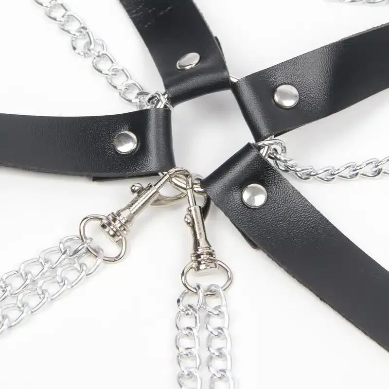 Black leather bondage restraint with metal chains and silver hardware details