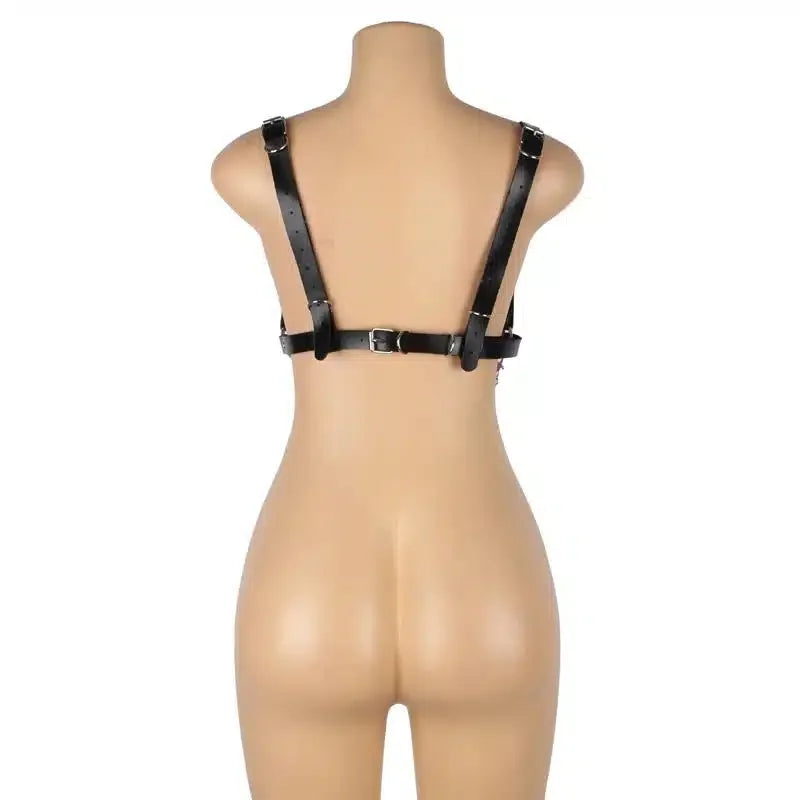 Mannequin from behind wearing adjustable black faux leather harness lingerie.