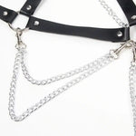 Black faux leather harness with silver metal chains and O-rings on white background