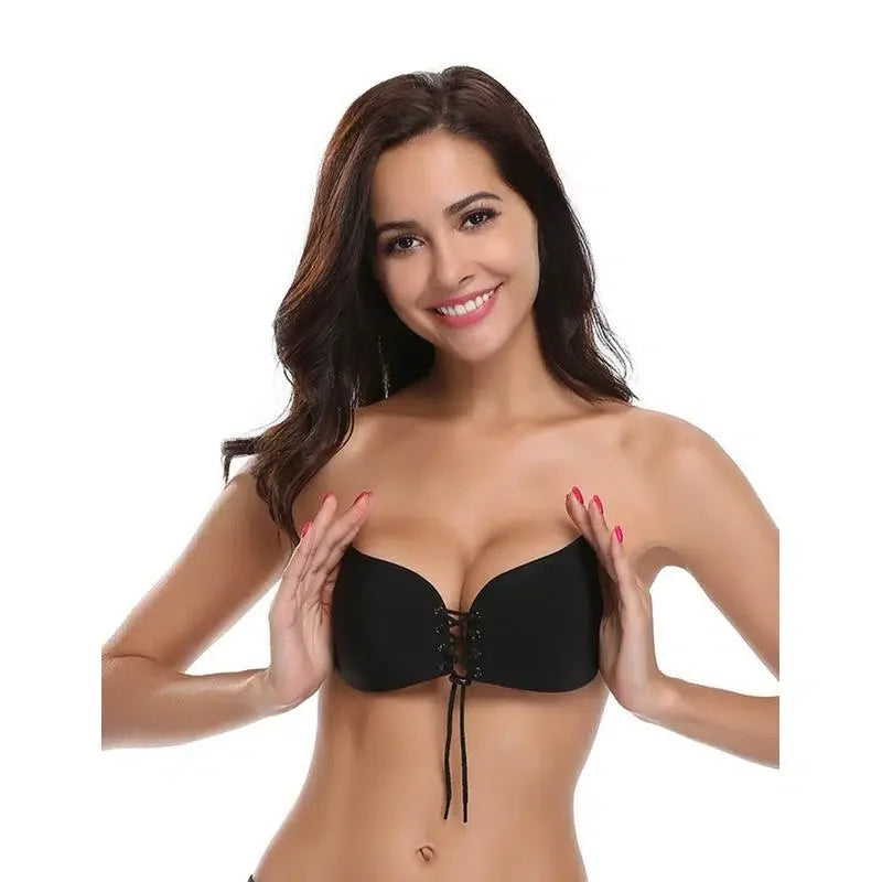 Woman wearing strapless black lace-up bra, demonstrating push-up lingerie support
