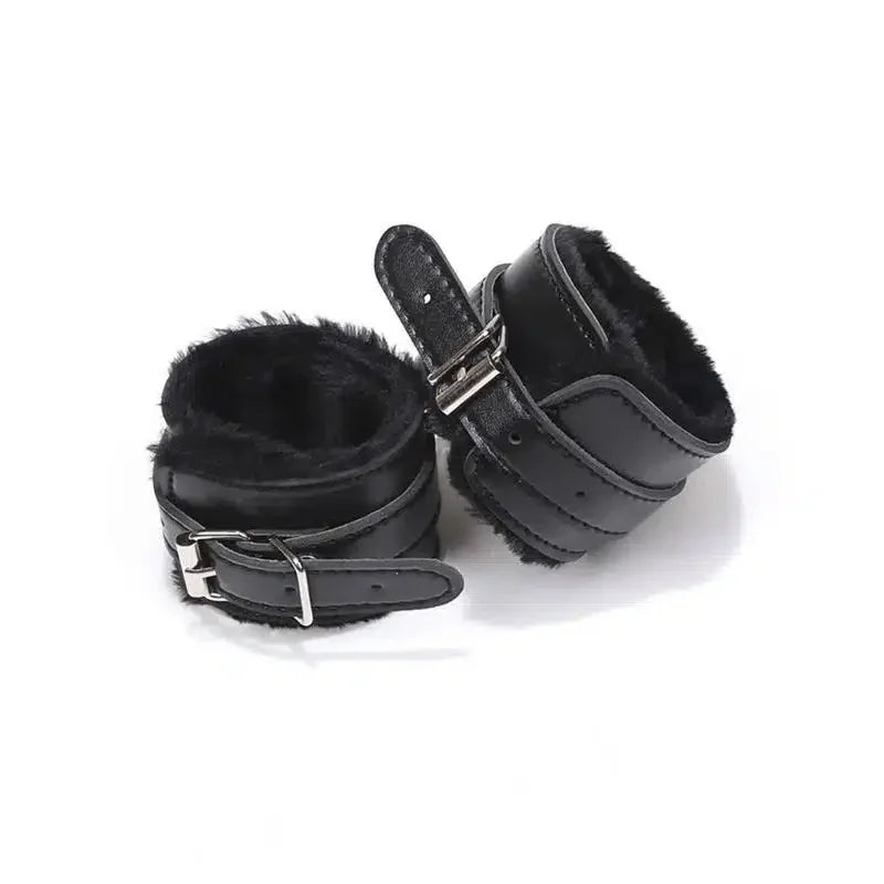 Black faux fur lined wrist restraints with adjustable buckle straps on white background