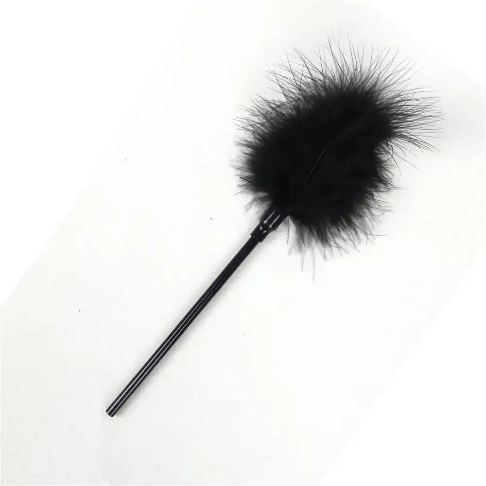 Black feather tickler on white background, sensual accessories, intimate couples product