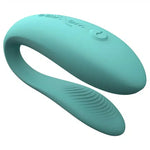 Teal silicone couples vibrator with curved design and textured surface, intimate wellness product