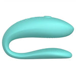 Turquoise silicone couples vibrator with ergonomic, curved design on white background