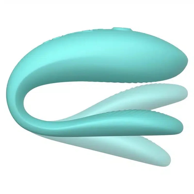Teal flexible silicone couples vibrator with curved design and textured surface