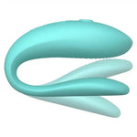 Teal flexible silicone couples vibrator with curved design and textured surface