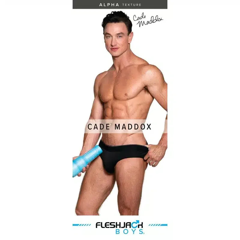 Muscular man in black underwear posing with blue personal pleasure product, white background.