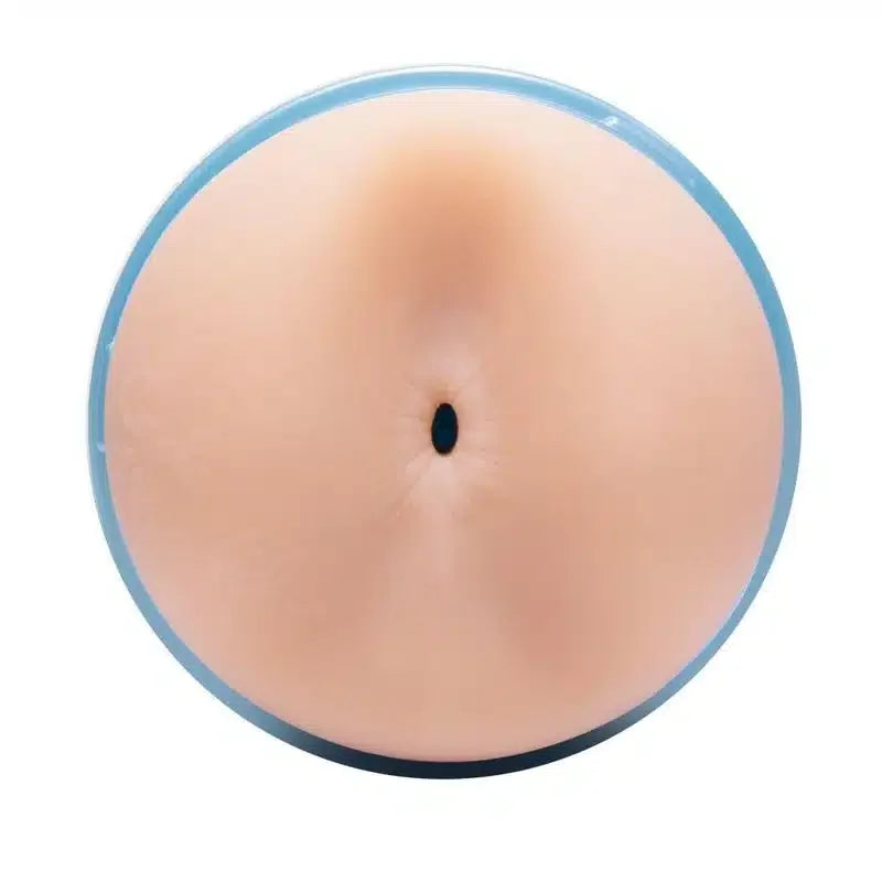 Realistic round adult toy with skin-tone detail, photographed from above against white background.
