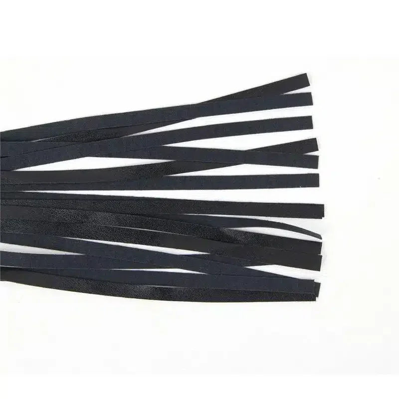 Black faux leather flogger whip with multiple strips on white background