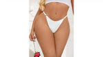 Woman in white thong lingerie and crop top holding red rose, sensual underwear fashion