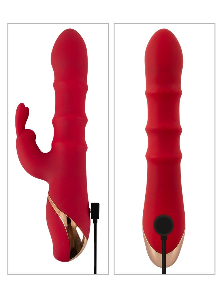 Rabbitvibrator med USB-magnetladekabel ved siden av – viser inkludert tilbehør.