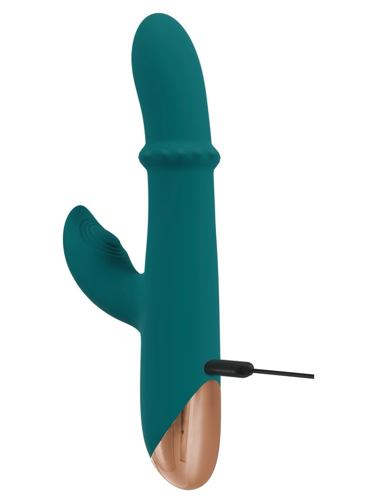 Thumping Rabbitvibrator med magnetisk ladekabel tilkoblet på siden.