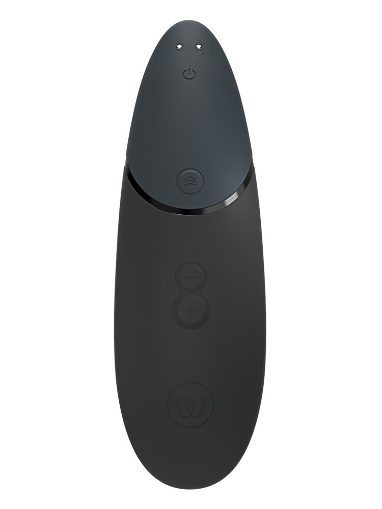 Womanizer Next sort sett bakfra, med kontrollpanel og magnetiske ladekontakter øverst.