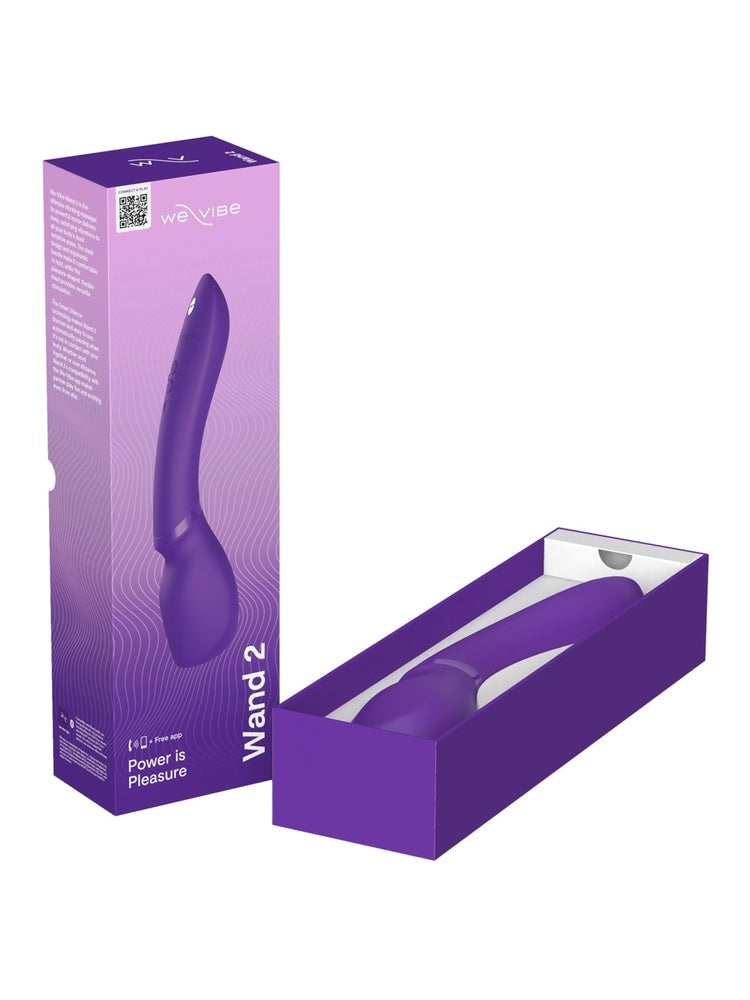 We-Vibe Wand 2 produkteske og innhold – lilla emballasje med sexleketøy, ladekabel og brukerveiledning
