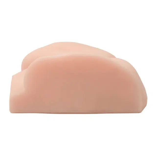 Realistic silicone buttocks adult toy with lifelike skin tone on white background.
