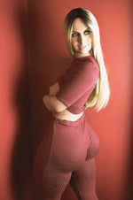 Realistic female doll with long blonde hair wearing matching ribbed maroon loungewear set.