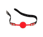 Red silicone ball gag with adjustable black strap and metal buckle, adult accessory