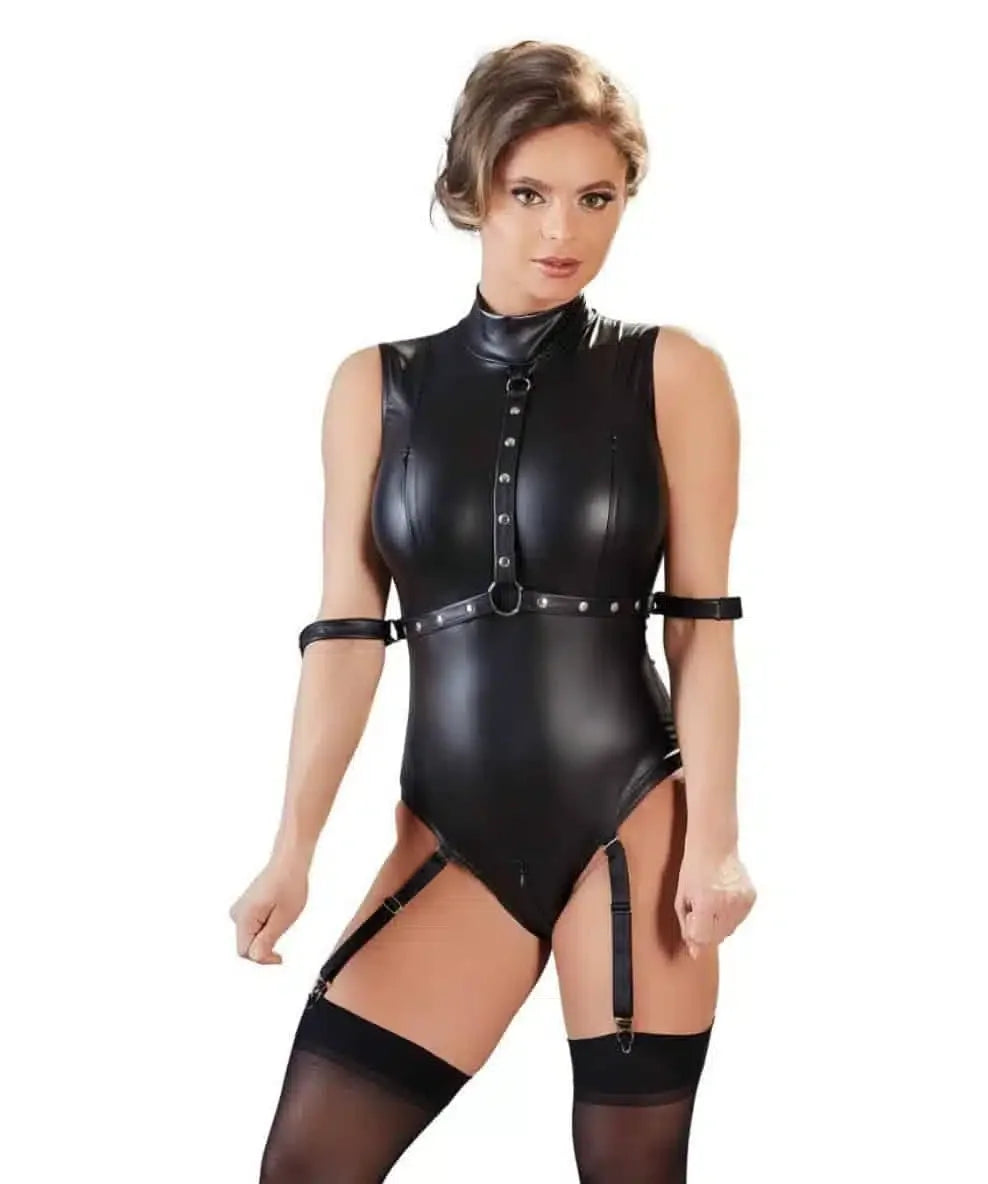 Woman in black faux leather lingerie bodysuit with harness straps and garters