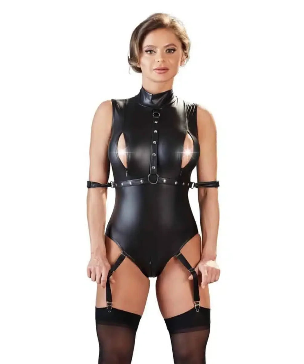 Woman wearing black faux leather bondage lingerie bodysuit with garters and stockings