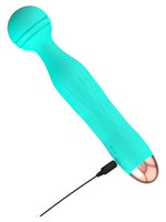 Cuties Minivibrator med ladekabel tilkoblet – viser magnetisk USB-lading ved den gullfargede basen