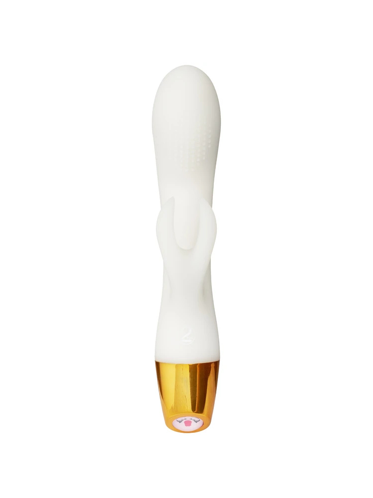 You2Toys Glow in the Dark Rabbit Vibrator bakfra – hvit rabbitvibrator med buet form, klitorisstimulator og gullfarget base mot lys bakgrunn.